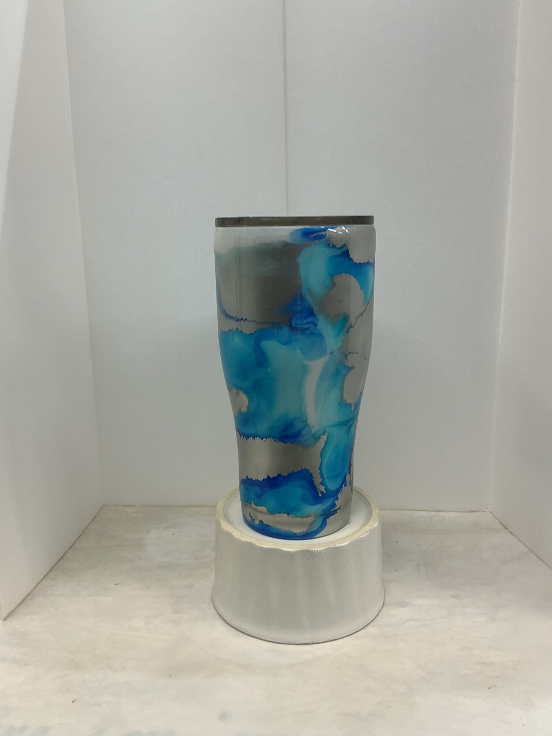 Blues and silver jewelry piece by Nancy’s Designs featuring intricate silver details and vibrant blue accents.