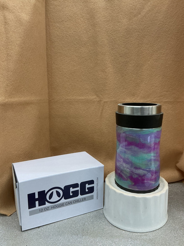 Pastel insulated tumbler with purple, blue, and green marbled design, black lid, on a white stand, with a Nancy’s Designs branded box nearby.