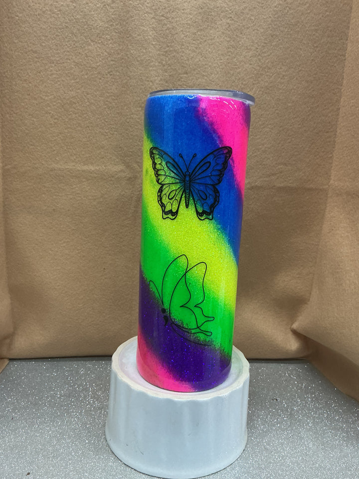 Colorful butterfly-themed can with neon green, pink, blue, and purple swirls, featuring black butterfly line art, on a white stand.