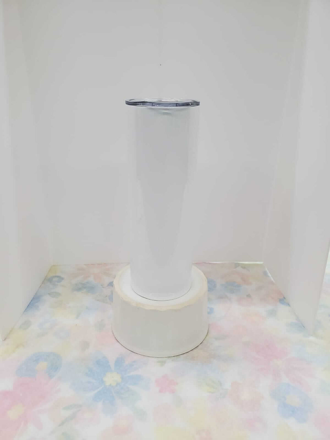 Custom Nancy Designs 20 oz tumbler with colorful, personalized design on stainless steel surface for hot and cold beverages.